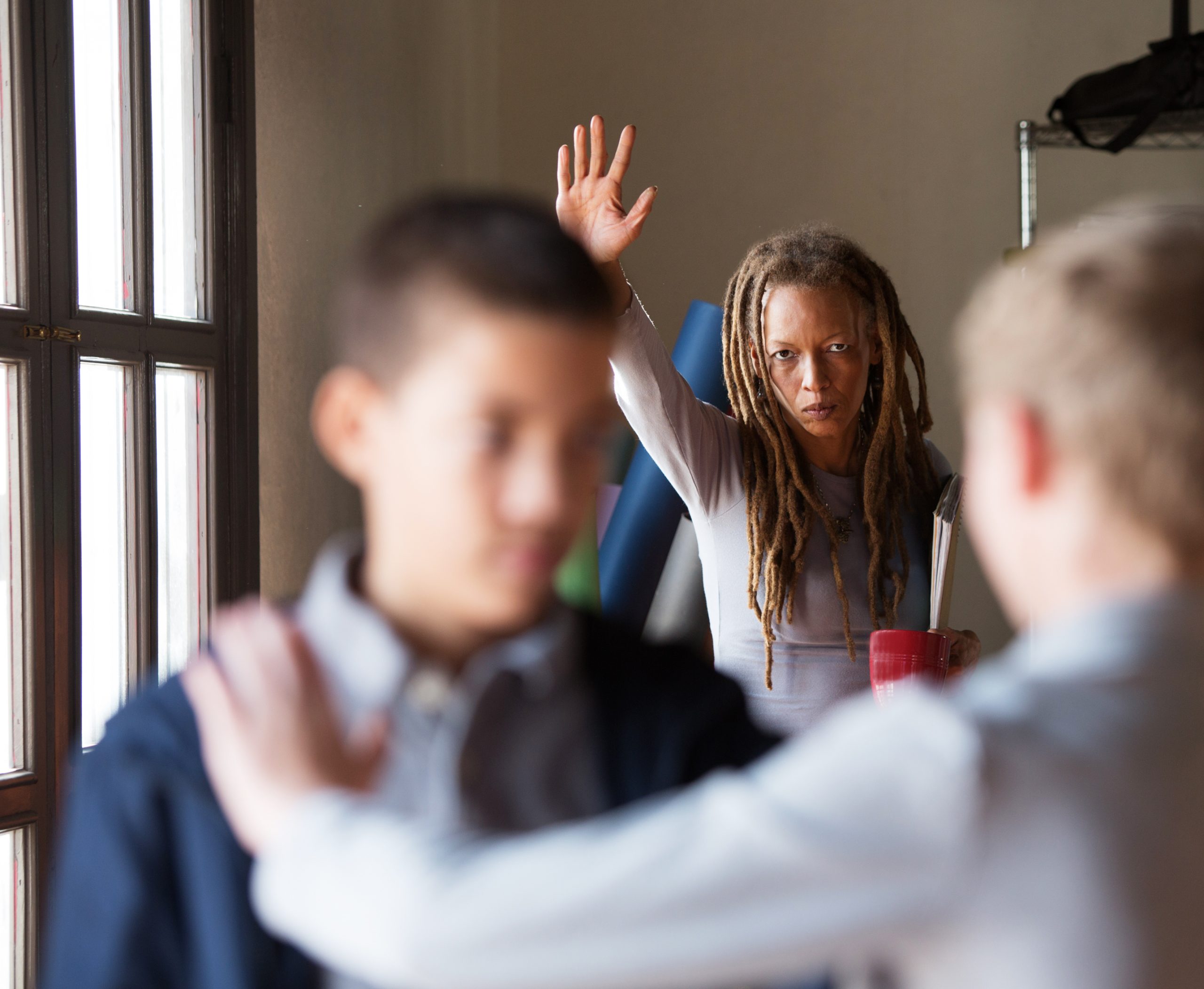 Black,And,White,Teenage,Boys,Fighting,With,Teacher,In,Background